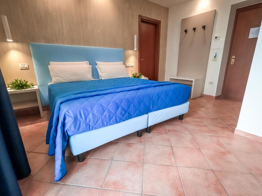 Postel nebo postele na pokoji v ubytování Hotel Martino