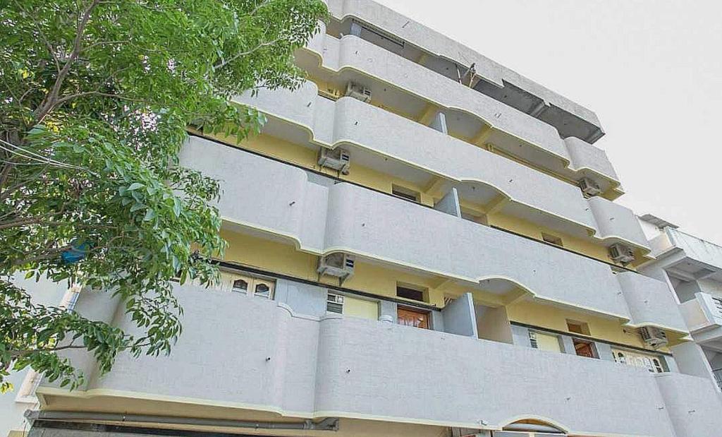 a white building with windows on the side of it at Collection O Blossom Suites in Bangalore