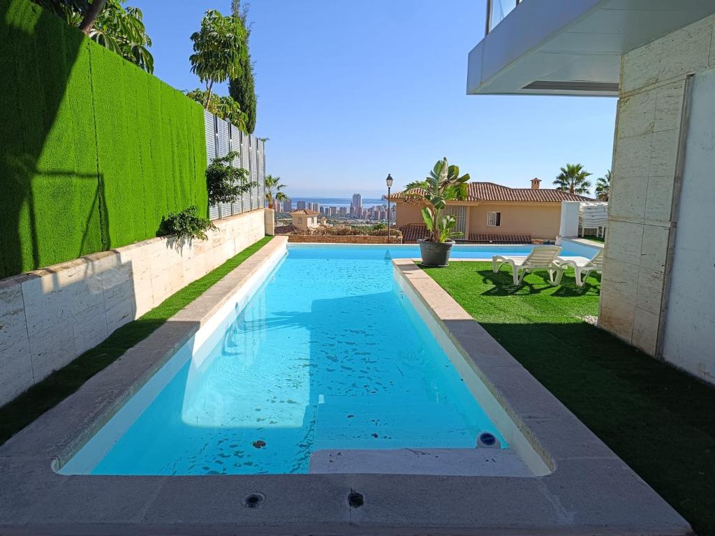 a swimming pool in the backyard of a house at Villa Ipanema Benidorm in Finestrat