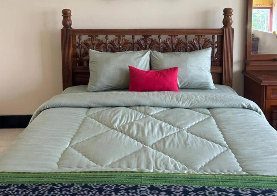 Tempat tidur dalam kamar di Sekar Wangi Homestay