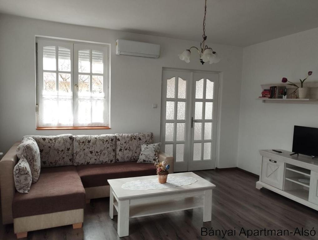 a living room with a couch and a coffee table at Bányai Apartman in Gyula