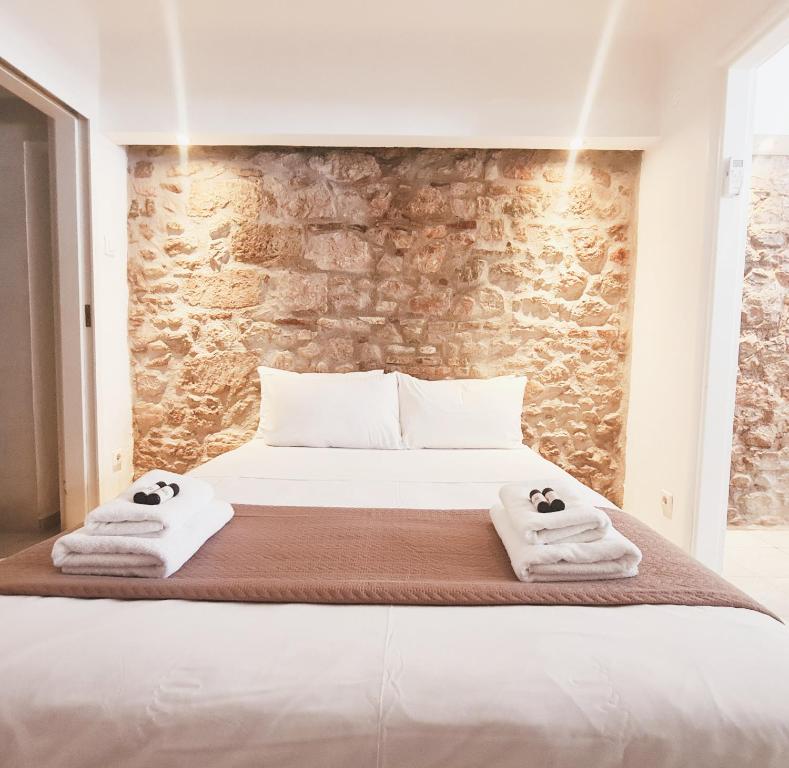 a bedroom with a bed with towels on it at Nephiria, Back to Tradition, In the heart of Plaka! in Athens