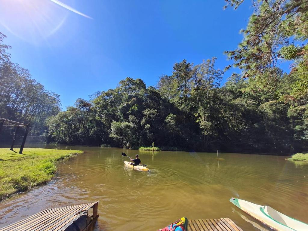 a person in a kayak on a river at Pedra Grande Adventure Park in Atibaia