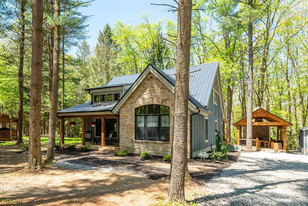 a house in the woods with trees at West Oak - hot tub, boat slip, outdoor fireplace in Oakland