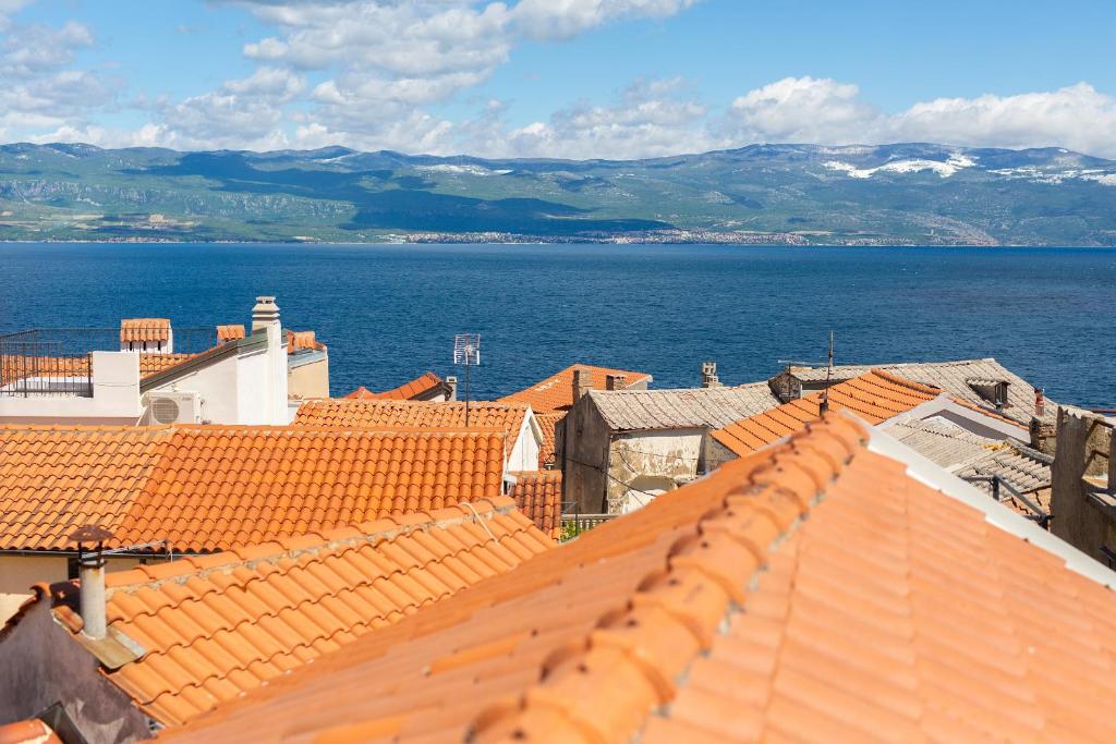 a view of the roofs of buildings and the ocean at VRBNIK OLD CITY LOFT in Vrbnik