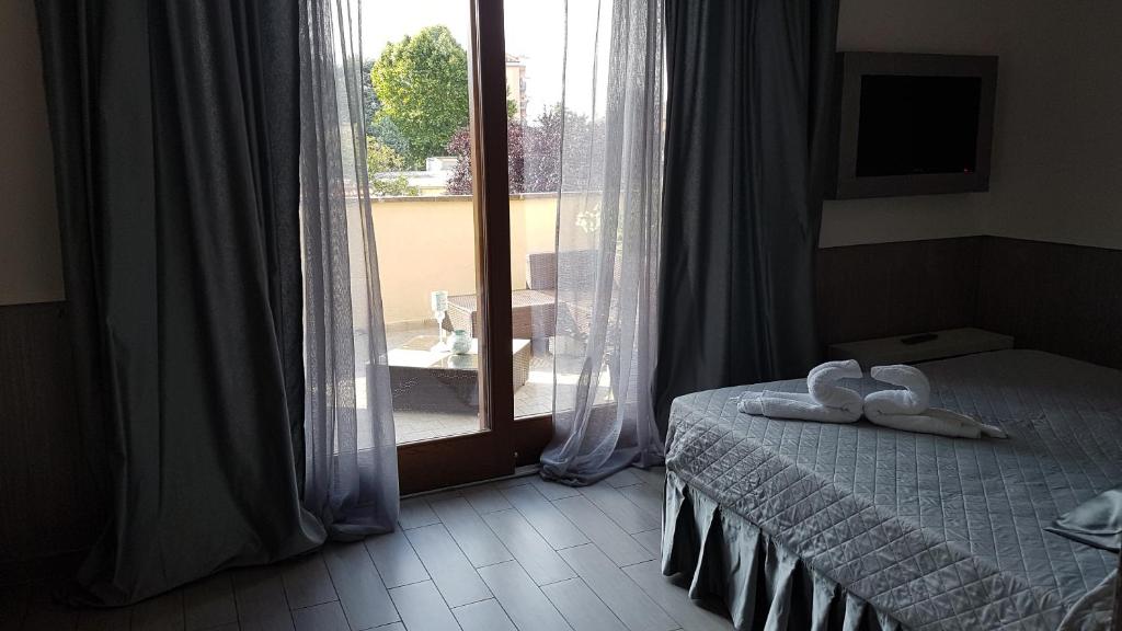 Posteľ alebo postele v izbe v ubytovaní ILLUVIA affitto camere