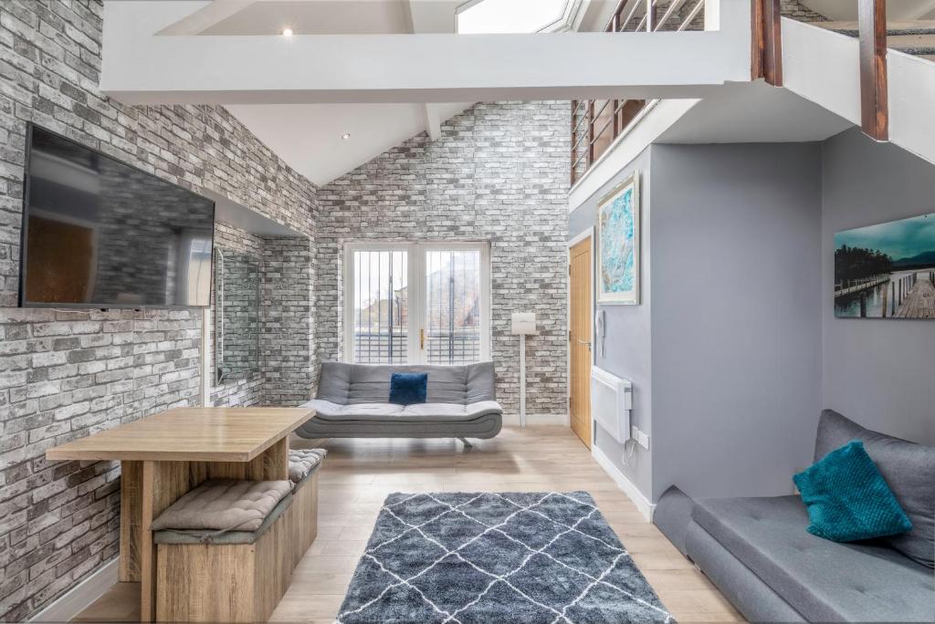 a living room with a brick wall at Darlington Luxury Penthouse in Darlington
