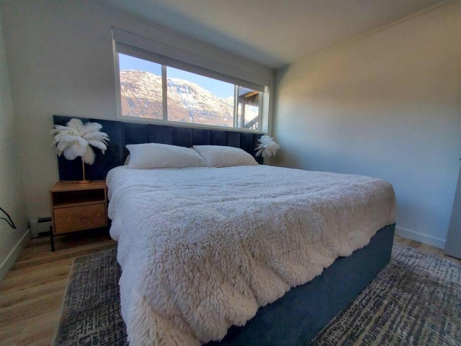 a bedroom with a large bed and a window at Updated Douglas Apartment, Close to Sandy Beach in Juneau
