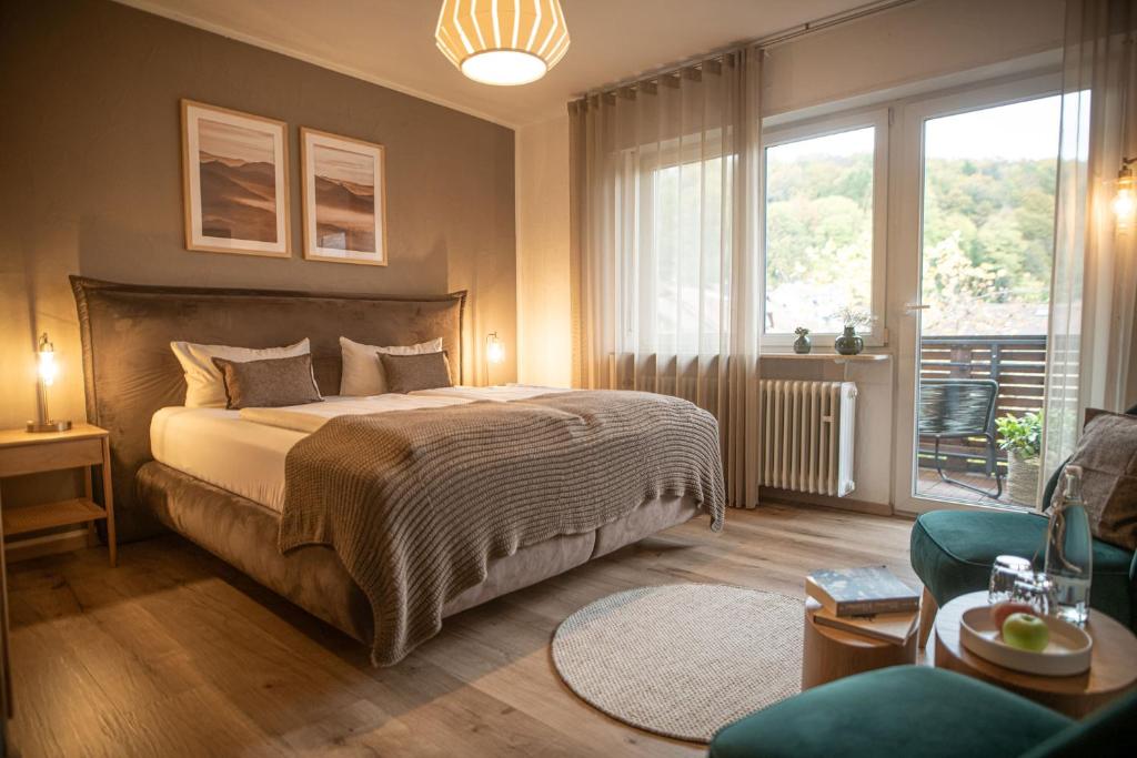a bedroom with a bed and a living room at Landgasthaus & Hotel zur Krone in Dahn