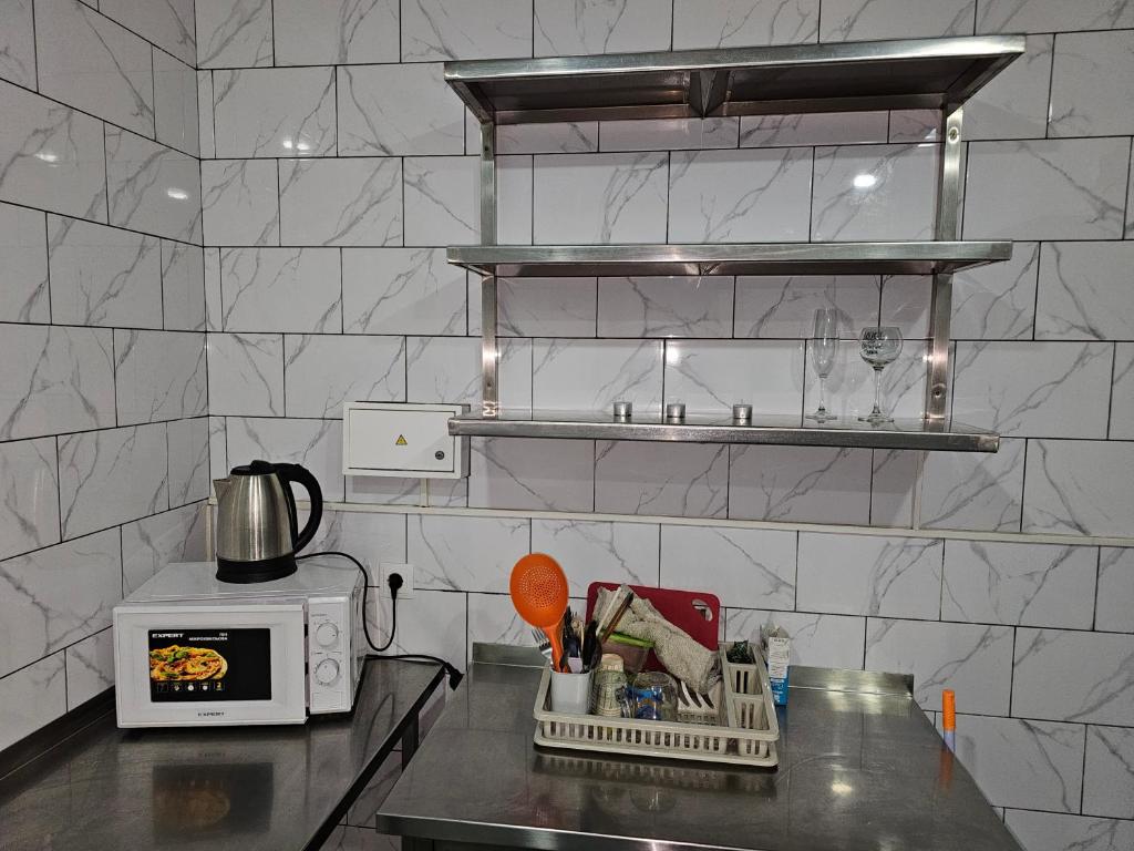 a kitchen with a counter top with a microwave at PerfectHotel in Myrhorod