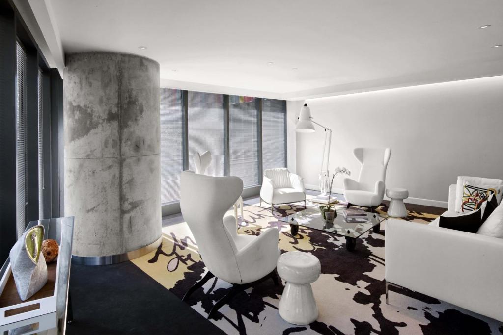 a living room with white chairs and a table at DUA Miami, Autograph Collection in Miami