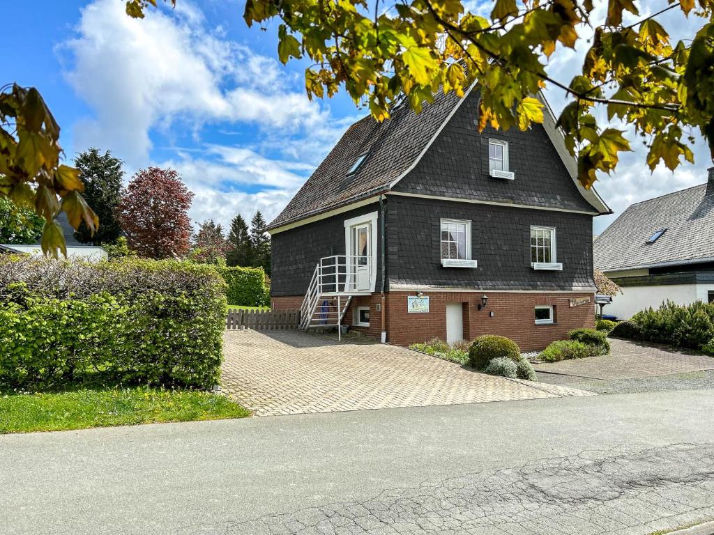 a house with a gray roof and a staircase on it at Zum Heidegarten in Winterberg