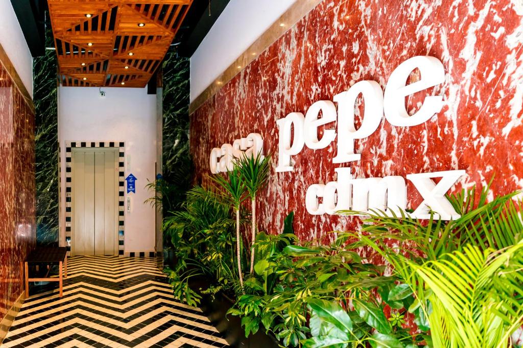 a lobby of a hotel with a sign that reads pop quiz at Casa Pepe in Mexico City