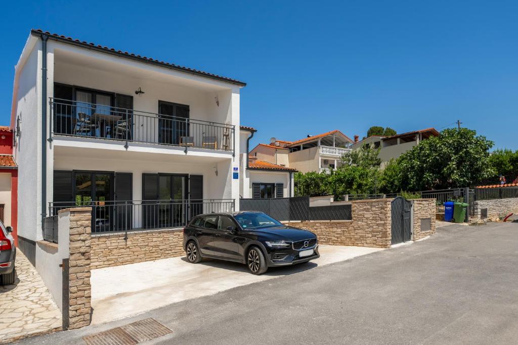 a car parked in front of a house at Luxury Apartments Villa San Avia in Banjole