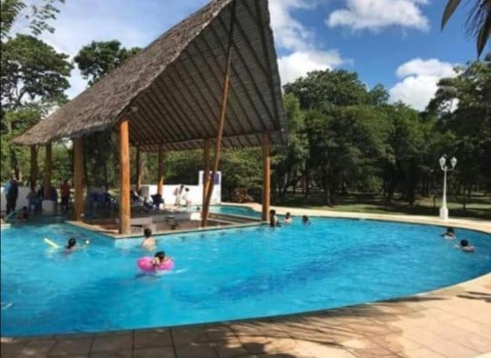 a group of people in a swimming pool with a gazebo at CABAÑA ECOLOGICA PARAISO in Santa Cruz de la Sierra