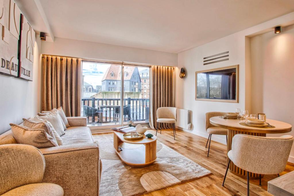 un salon avec un canapé et une table dans l'établissement L'Orient Express - 2 Pièces - 1 chambre - Deauville, à Deauville
