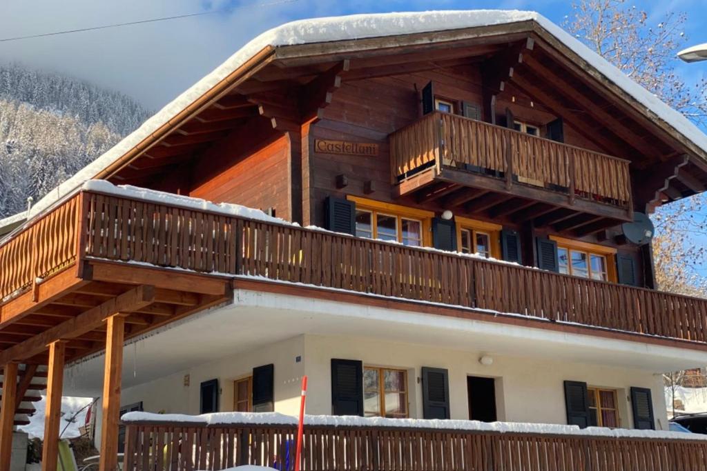a large house with a balcony on top of it at Chalet Castellani Duplex in Fiesch