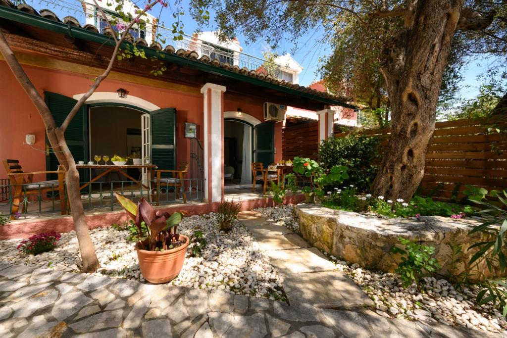 a house with a tree in front of it at Pieros Studio Tsimis in Paleokastritsa