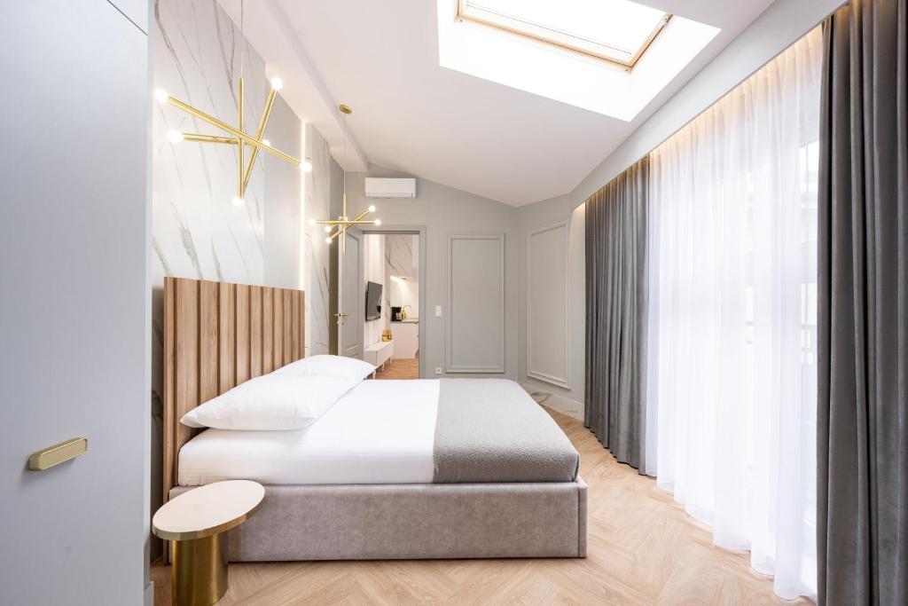 a hotel room with a bed and a skylight at Native Apartments Starowiślna 43/15 in Krakow
