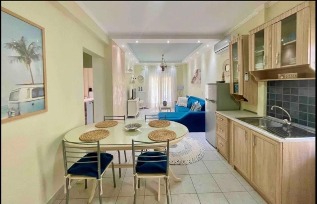 a kitchen and dining room with a table and chairs at Olivia - Christine's House in Afitos