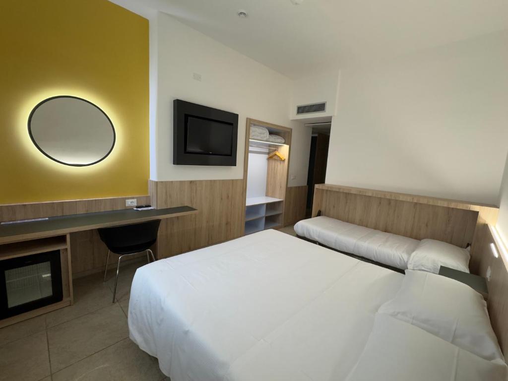 - une chambre d'hôtel avec un lit et un miroir dans l'établissement Hotel Holidays, à Roccaraso