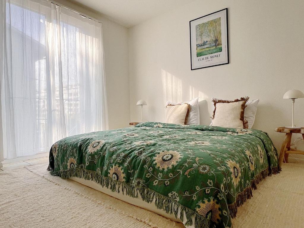 um quarto com uma cama com um edredão verde em Charmantes Apartment inmitten Zürich-Affoltern & Netflix! em Zurique