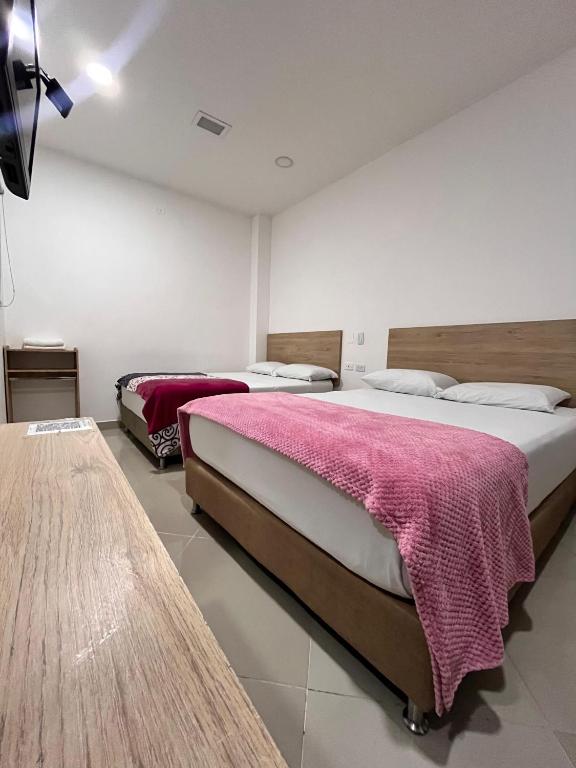Postel nebo postele na pokoji v ubytování Hotel Laureles Park