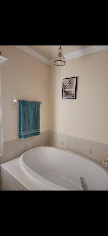 a bath tub in a bathroom with a blue towel at Beautiful Home with Pool in Cape Coral