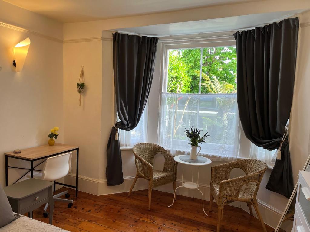 a dining room with a table and a window at Broadstairs Terrace: Central Broadstairs Flat in Broadstairs