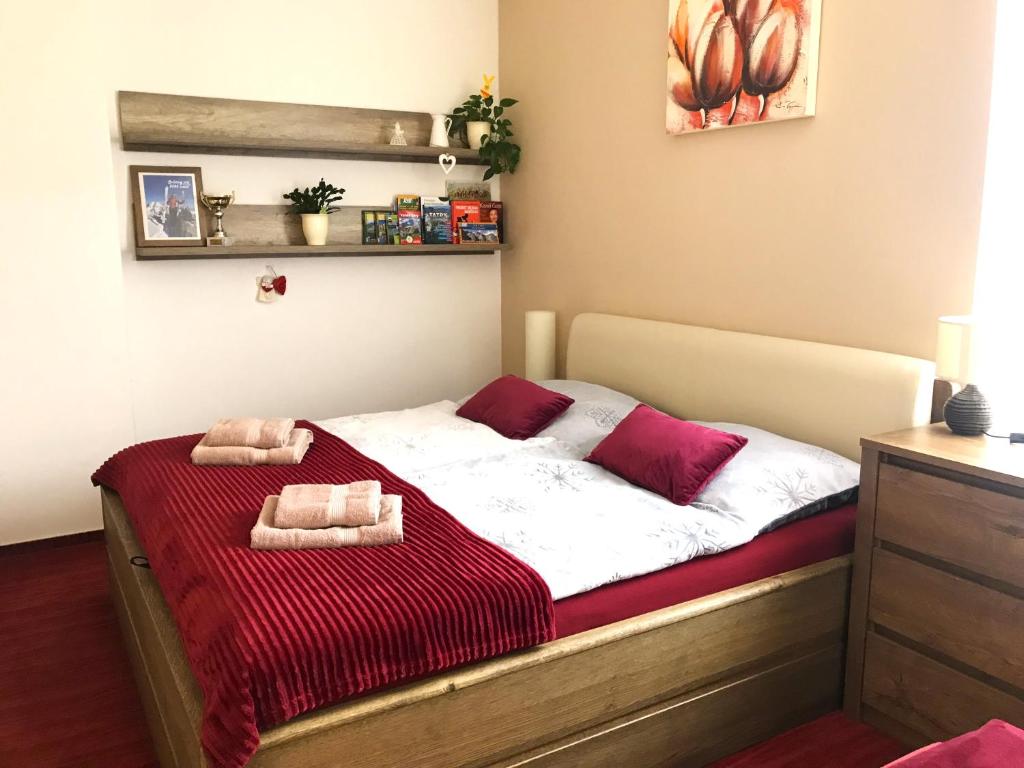 a bedroom with a bed with two towels on it at Apartmán Crocus 313 in Štrbské Pleso