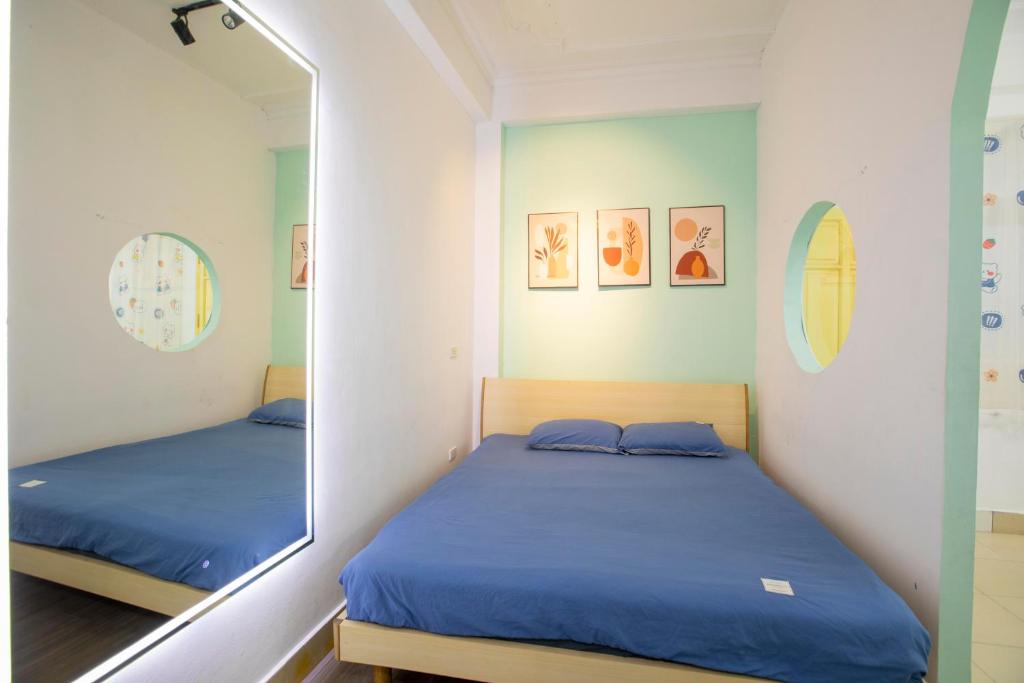 a bedroom with a mirror next to a bed at Promotion Quoc Tu Giam 202 in Hanoi