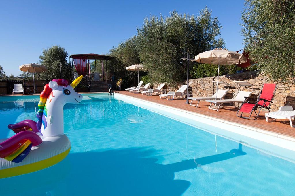 a swimming pool with a unicorn in the water at Casa del Lecceto in Campiglia Marittima