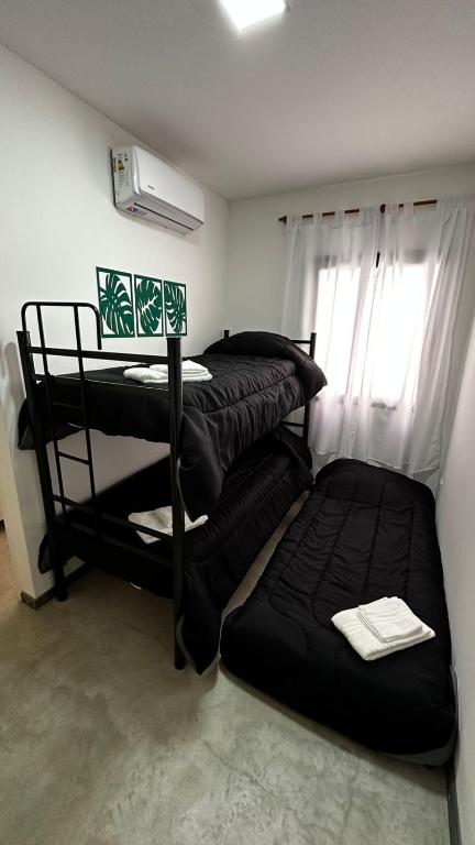 a room with two bunk beds and a window at DOCTA RESIDENCIA in Cordoba