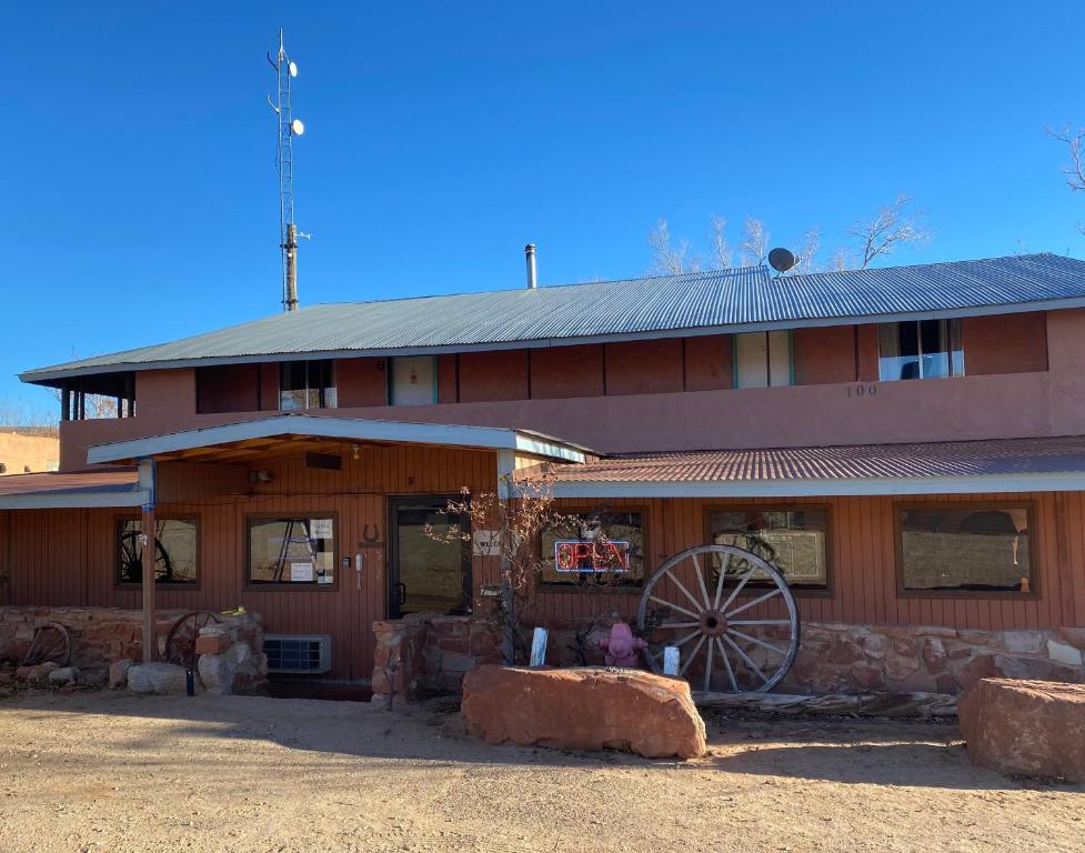 a large red building with a large wheel in front of it at Mexican Hat Lodge in Mexican Hat