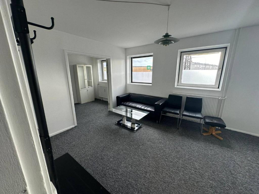 a living room with a couch and a table at Airport apartment in Copenhagen