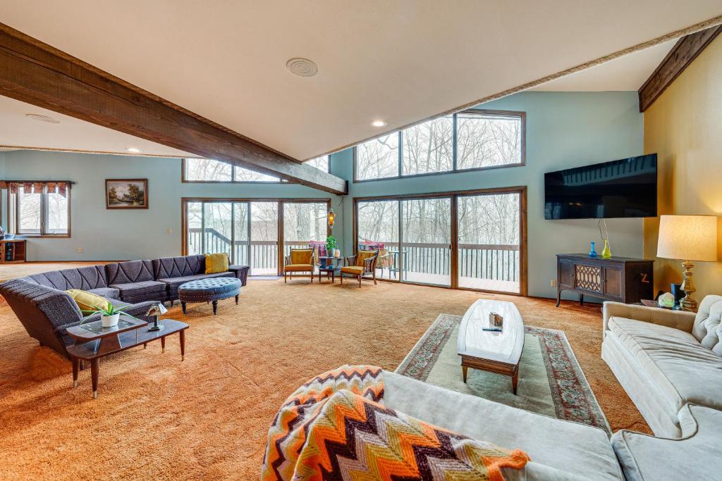 a large living room with couches and a tv at Eclectic Hubertus Home with Game Room and Fire Pit! in Germantown