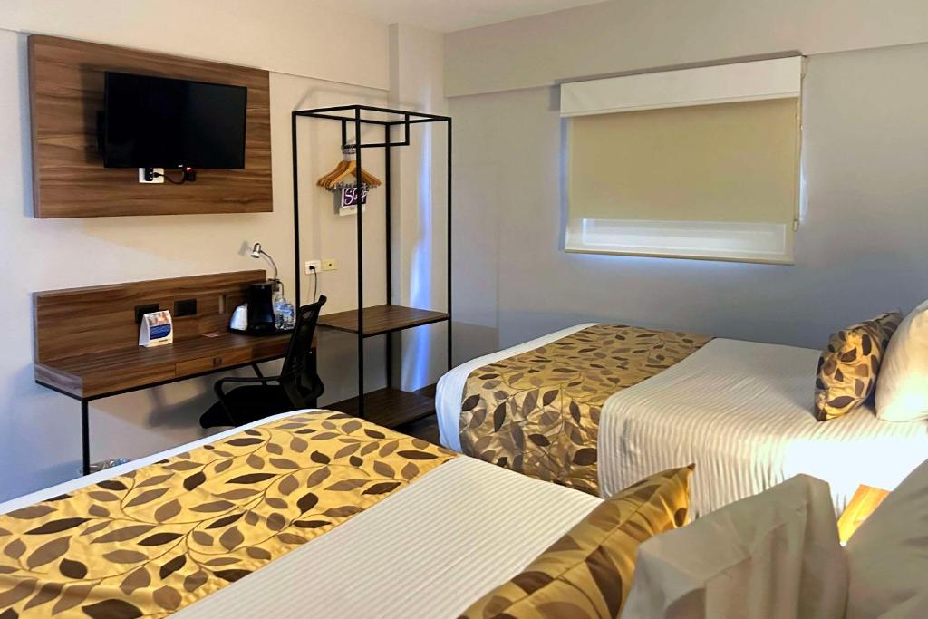 Postel nebo postele na pokoji v ubytování Sleep Inn Mazatlan