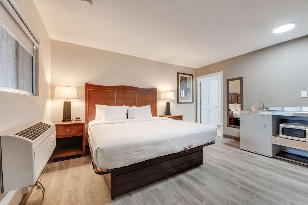 a hotel room with a bed and a sink at Suburban Studios near Mesa Verde in Cortez