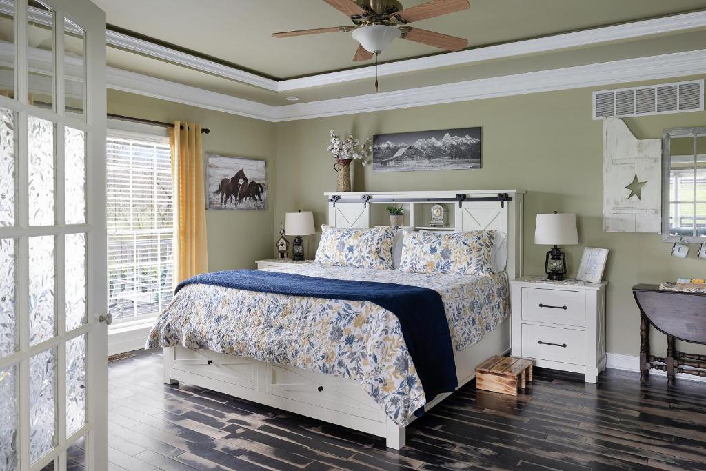 a bedroom with a bed and a ceiling fan at Pillow and Paddock B&B in La Grange