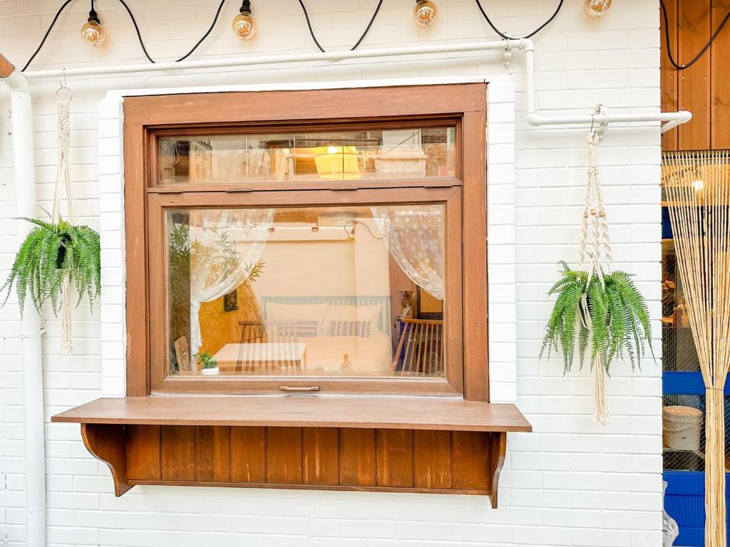 a window on a white building with plants in it at Yunseul- Garden House in the City with Korean Beauty in Seoul