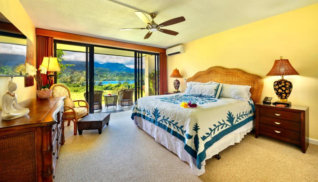 a bedroom with a bed and a desk and a window at BBs Biz E HBR 4104/5/6 in Princeville