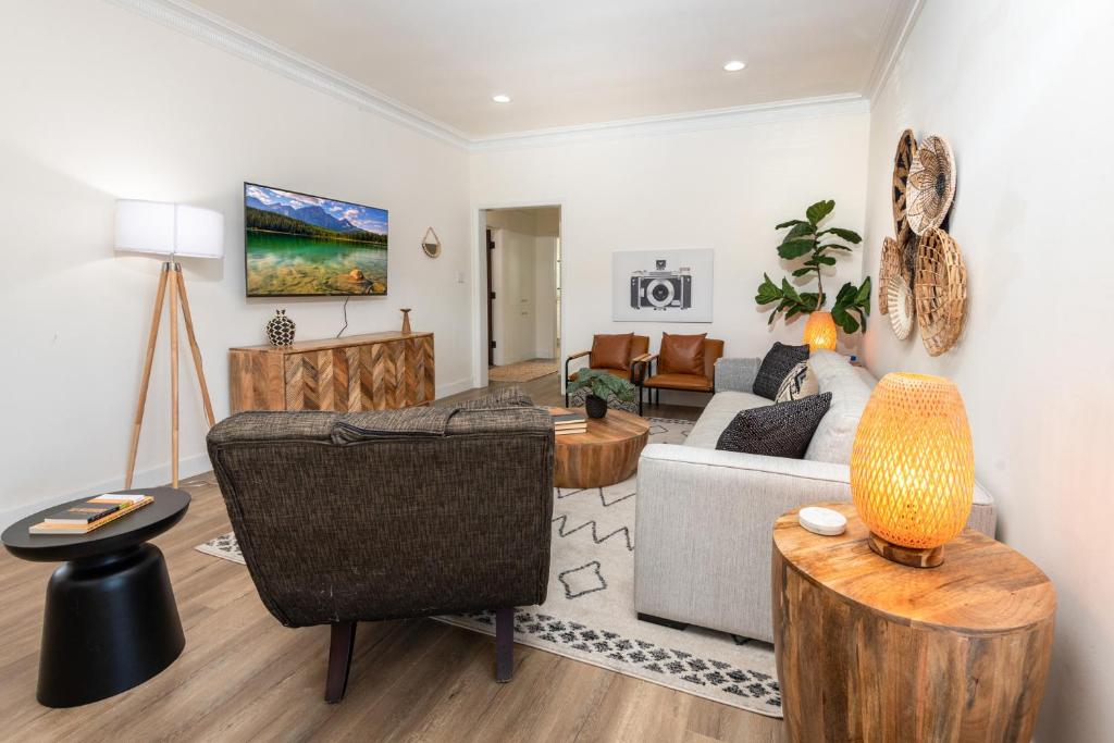 a living room with a couch and a table at Exquisite 1BR Suite ahead of Cedar-Sinai Hospital in Los Angeles