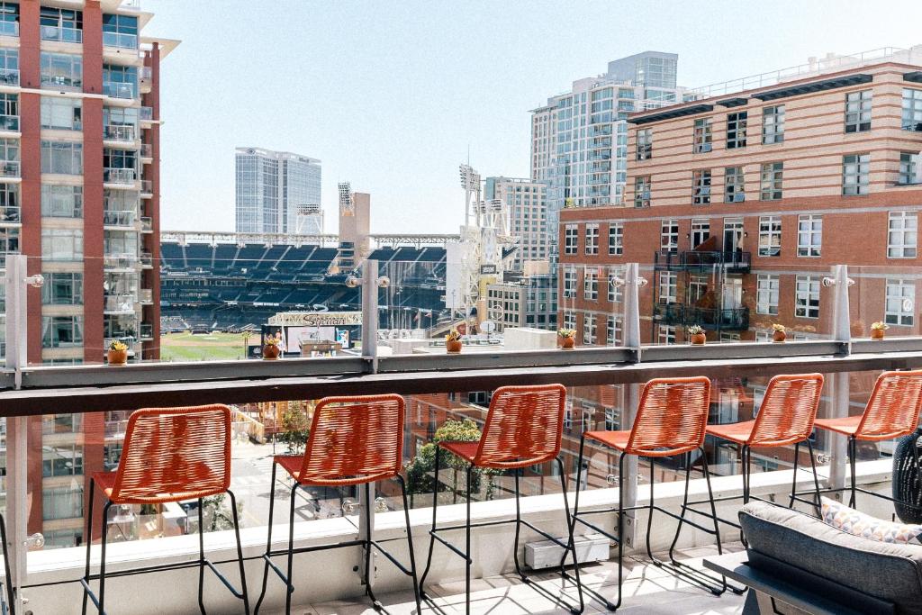 a group of chairs sitting on top of a balcony at Hotel Indigo San Diego - Gaslamp Quarter, an IHG Hotel in San Diego