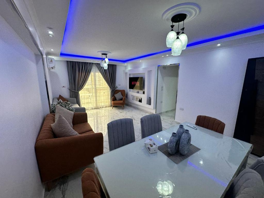 a living room with a dining table and a living room at Modern 3-Bedroom Apartment in Cairo