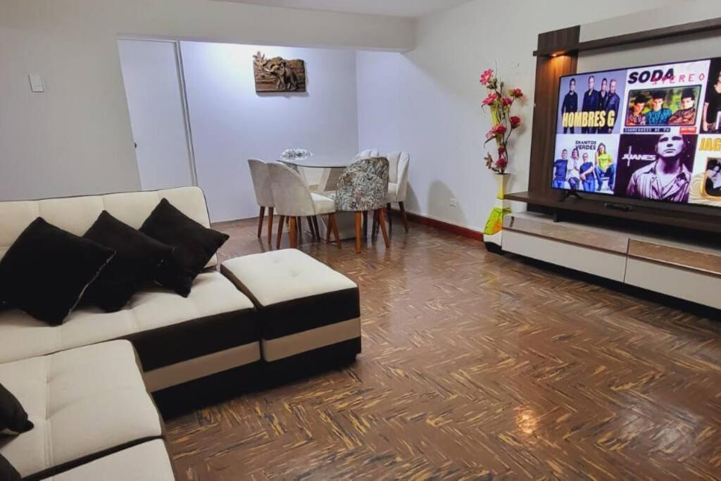 sala de estar con sofá y TV en Casa Familiar, Amplia , acojedora y equipada, en Cusco