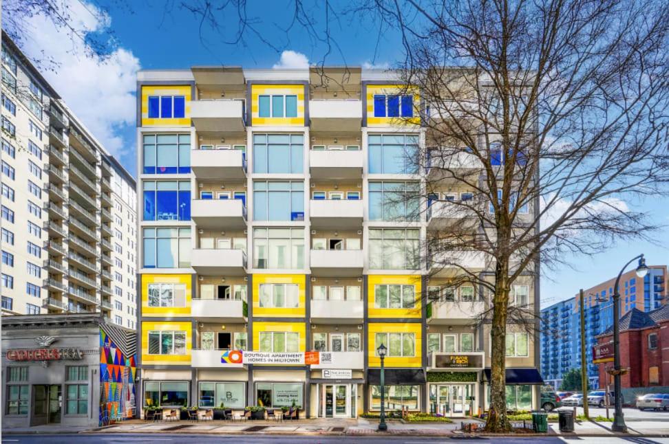 a tall building with yellow and blue windows at Stylish City Living Apartments with Free Parking in Midtown Atlanta in Atlanta