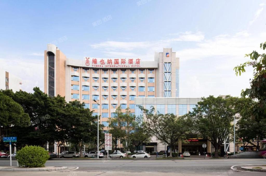 a large building with a sign on the front of it at Foshan Shiwan Hotel in Foshan