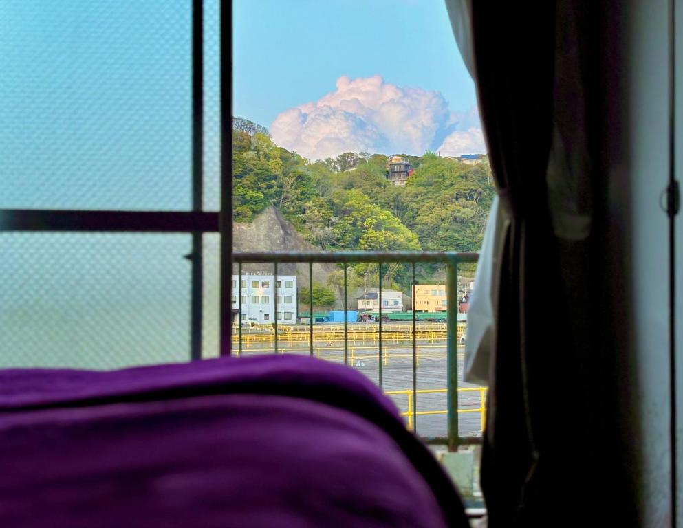a view of a mountain from a window at 酒と宿と不動産-yado- in Yokosuka