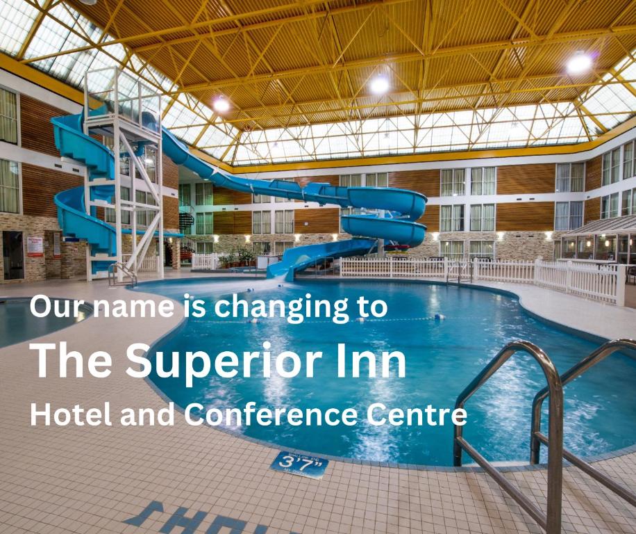 a pool with a slide in a hotel and conference centre at Superior Inn Hotel and Conference Centre Thunder Bay in Thunder Bay