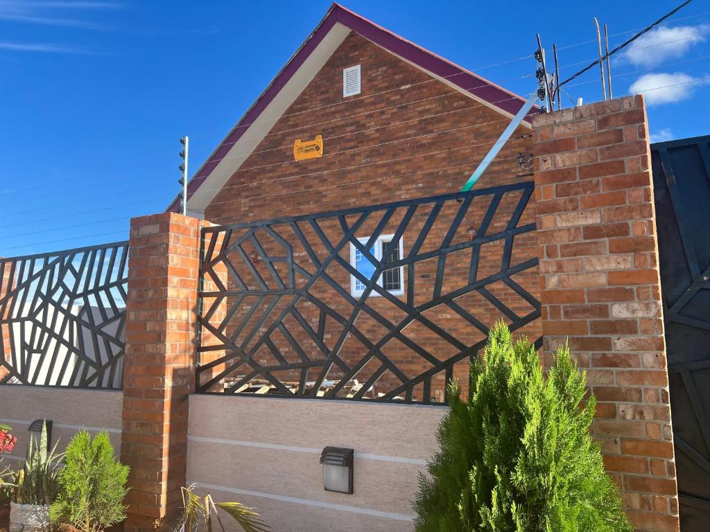 a brick building with a metal fence on it at Eastend homes in Dodoma